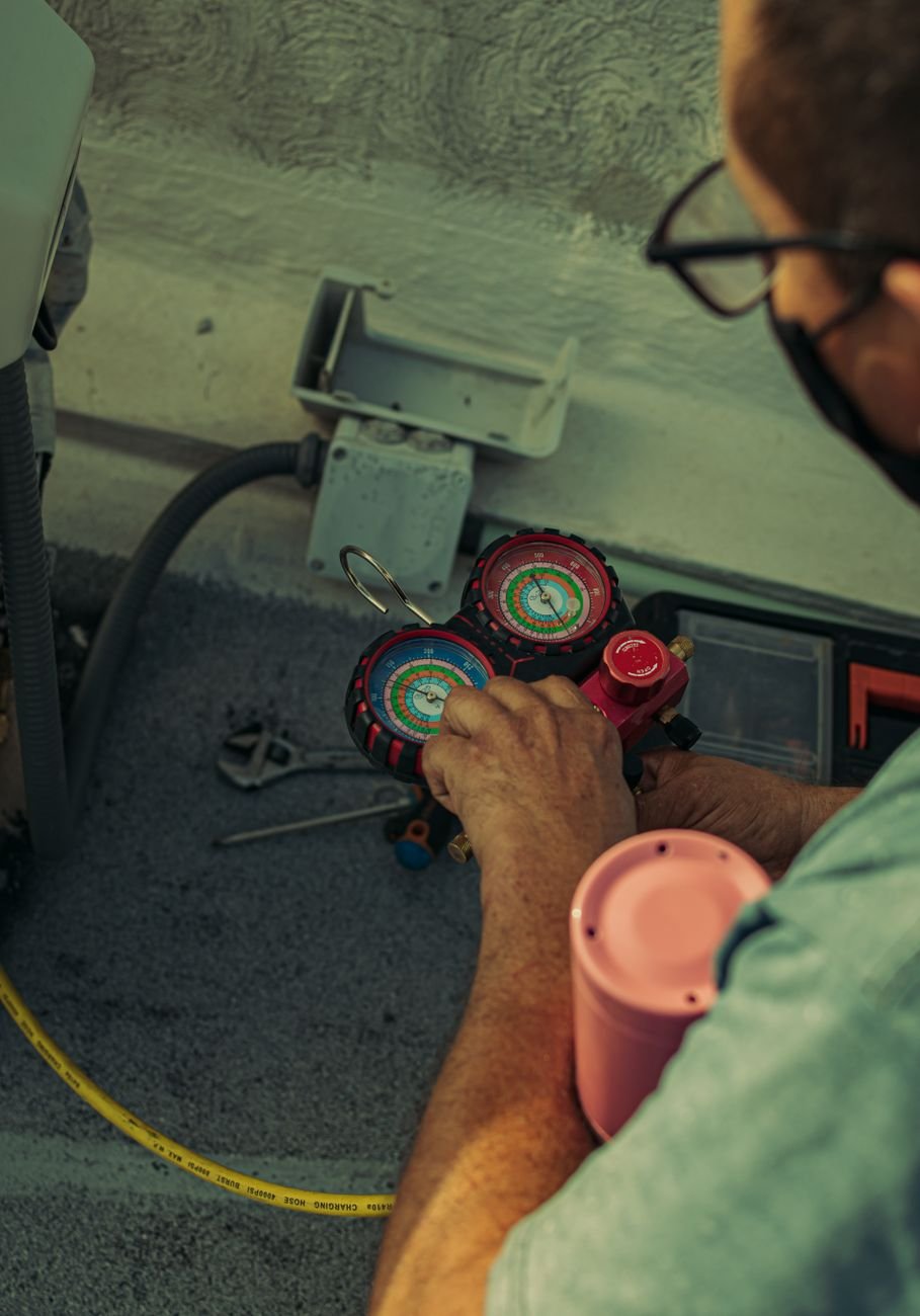 Close-up of a technician adjusting HVAC gauges